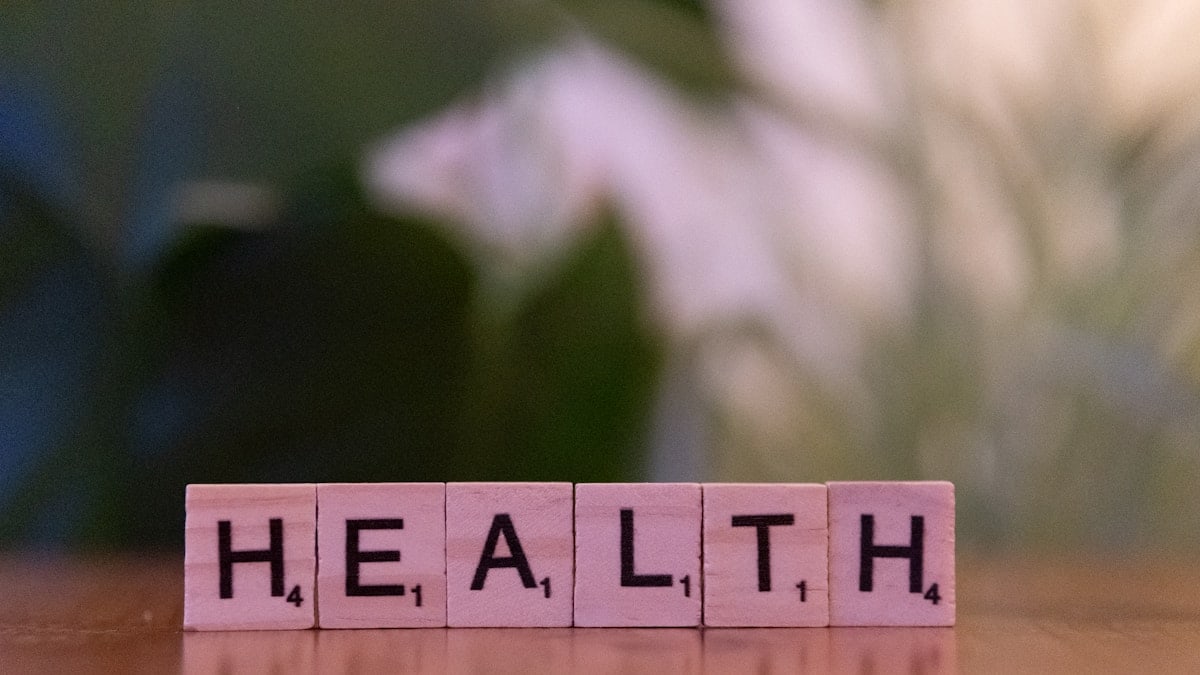 A wooden block spelling the word health on a table
